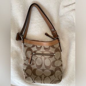 Coach monogram tote with leather straps. In great condition